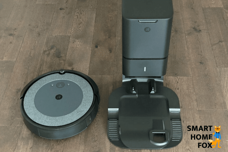 iRobot Roomba i3+ Saugroboter und die Absaugstation stehen nebeneinander auf dem Fußboden
